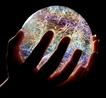 Crystal Ball lowing brilliant colors being held in someone's hands for a Psychic Reading